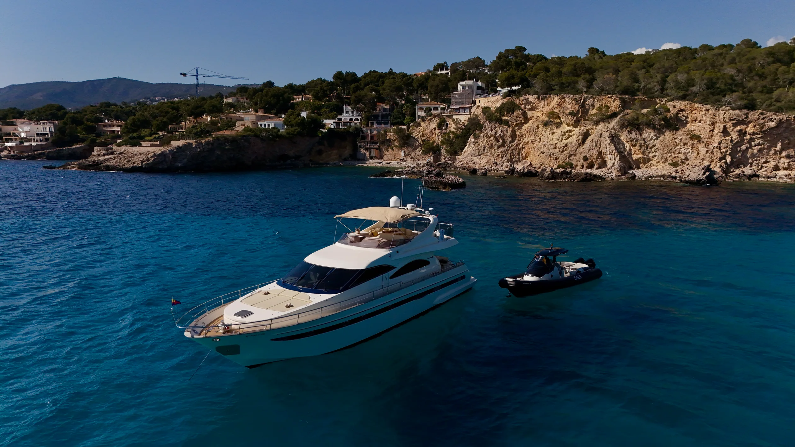 Lady Elbaum at anchor in a Mallorca cove with a jetski