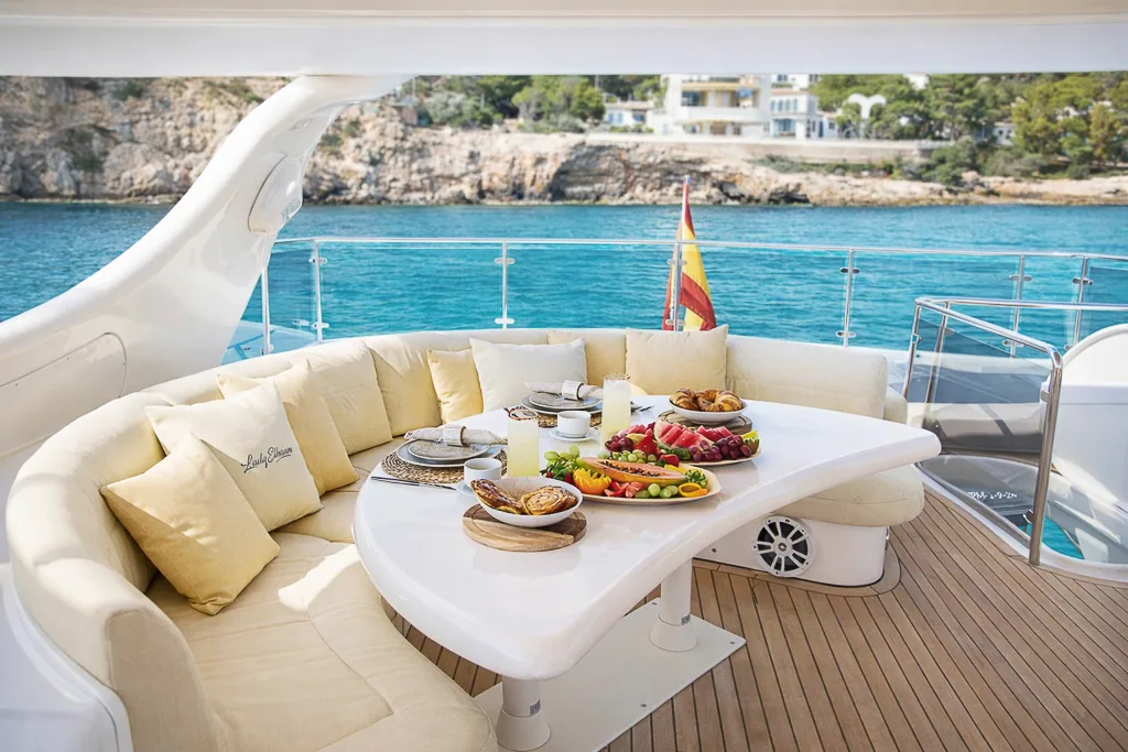 Breakfast on the aft deck of Lady Elbaum with Spanish flag, Mallorca