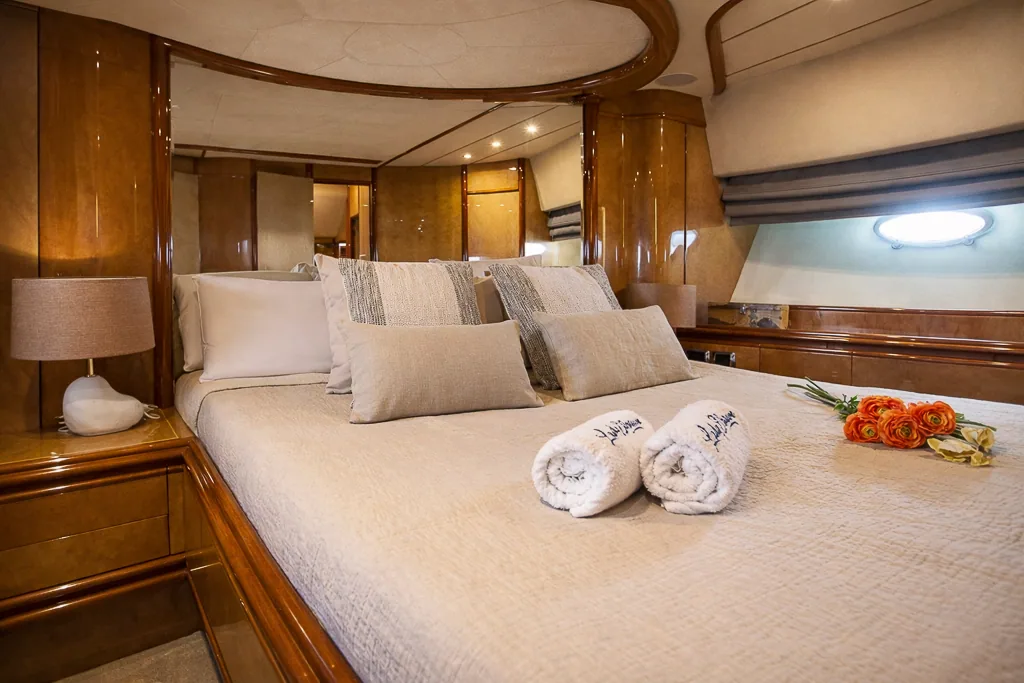 Master cabin of Lady Elbaum with rolled towels and ranunculus